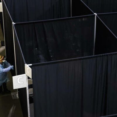 Medical workers wearing protective gear walk through the UMass Memorial Health Care field hospital at the DCU Center in Worcester, Massachusetts, U.S., on Wednesday, April 15, 2020. Covid-19 has infected 2 million people around the world as the new coronavirus marks another grim milestone. Photographer: Adam Glanzman/Bloomberg via Getty Images